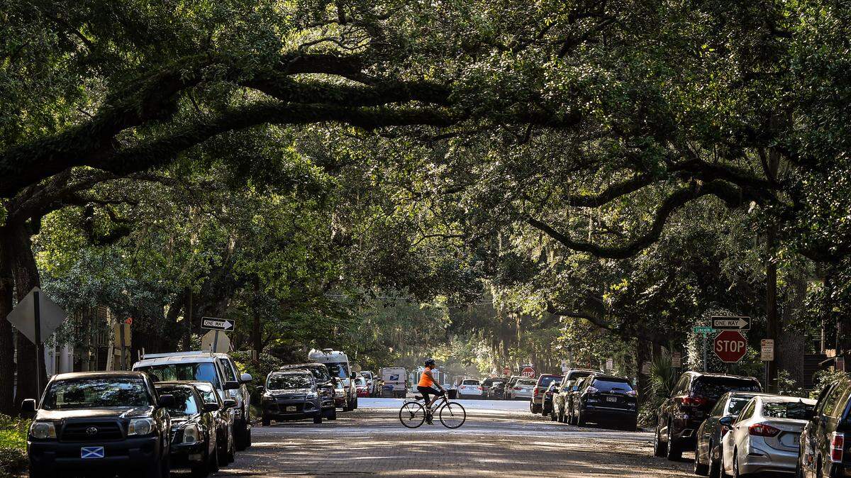 A woman rides her bike through the Historic District in Savannah, Georgia