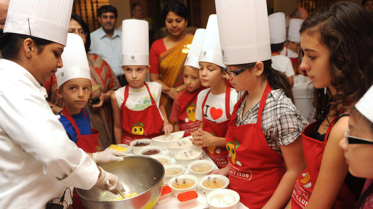 French children between the ages of six and twelve years old attend a special culinary session in New Delhi