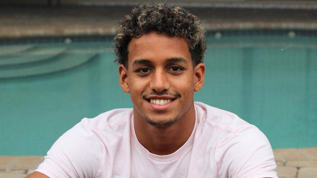Marcus Johnson, 19, poses for a photo at his family’s home in Coral Springs.
