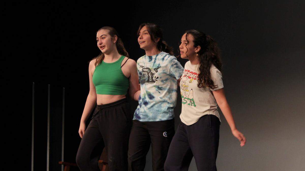 Mack Eckerty (left), Vera Lynch (center), and Emma Sillie (right) rehearse “Easy Street” for the Coral Springs Charter School’s production of “Annie Jr.”