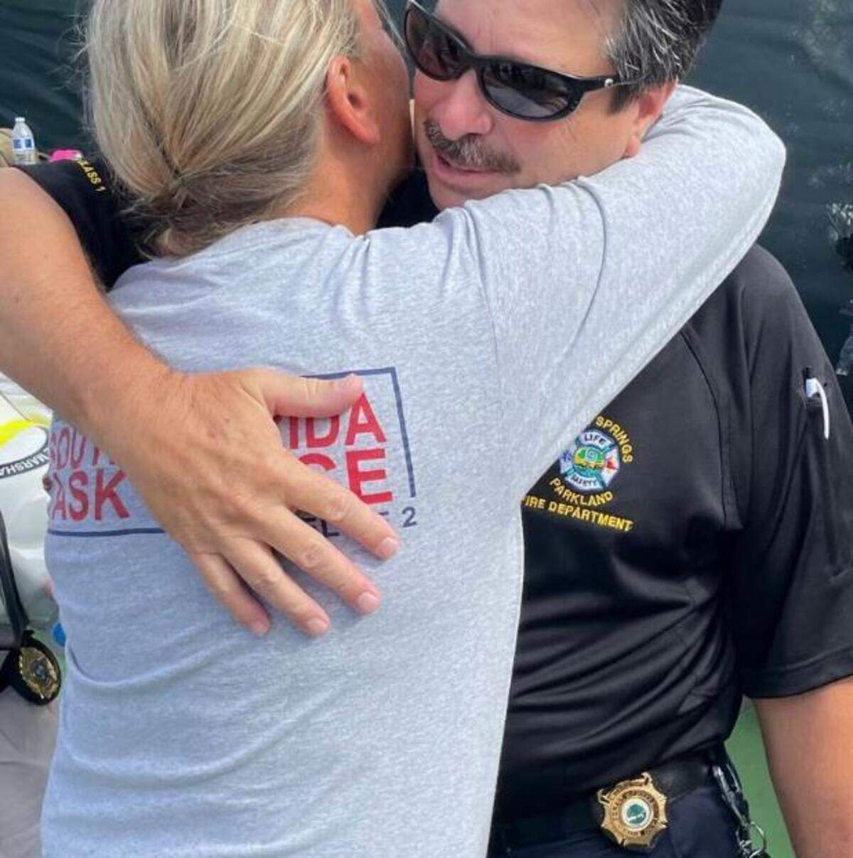 Captain Stephanie Palmer hugs Peer Support Team Member and former Fire Chief, Frank Babinec during her FEMA Urban Search and Rescue deployment to the 2021 Champlain Towers collapse in Surfside, which killed nearly 100 people.