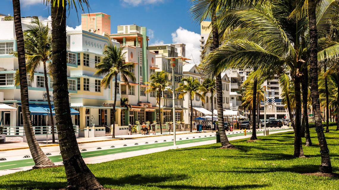 Ocean Drive and its colorful, pastel-colored tropical art deco houses and hotels with palm trees in Miami Beach, Florida