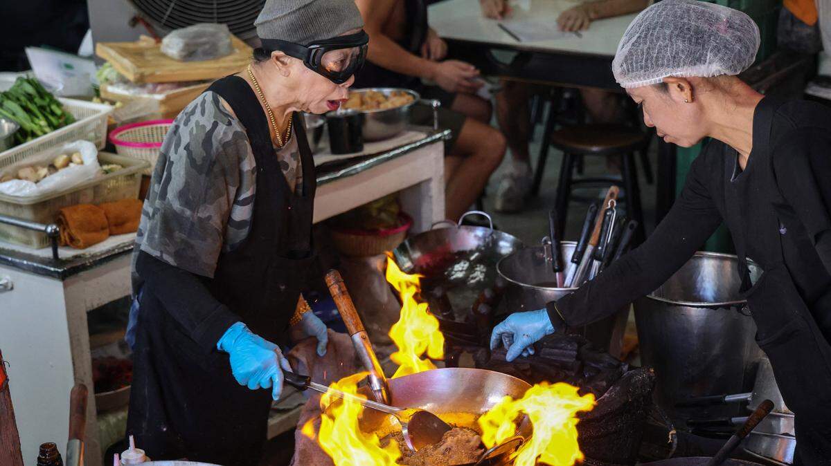 Michelin star chef Jay Fai cooks at her restaurant in Bangkok.