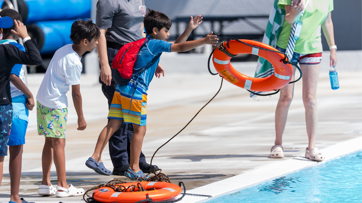 A child practices tossing a life preserver during the 2025 April Pools Day event at the Coral Springs Aquatic Complex.