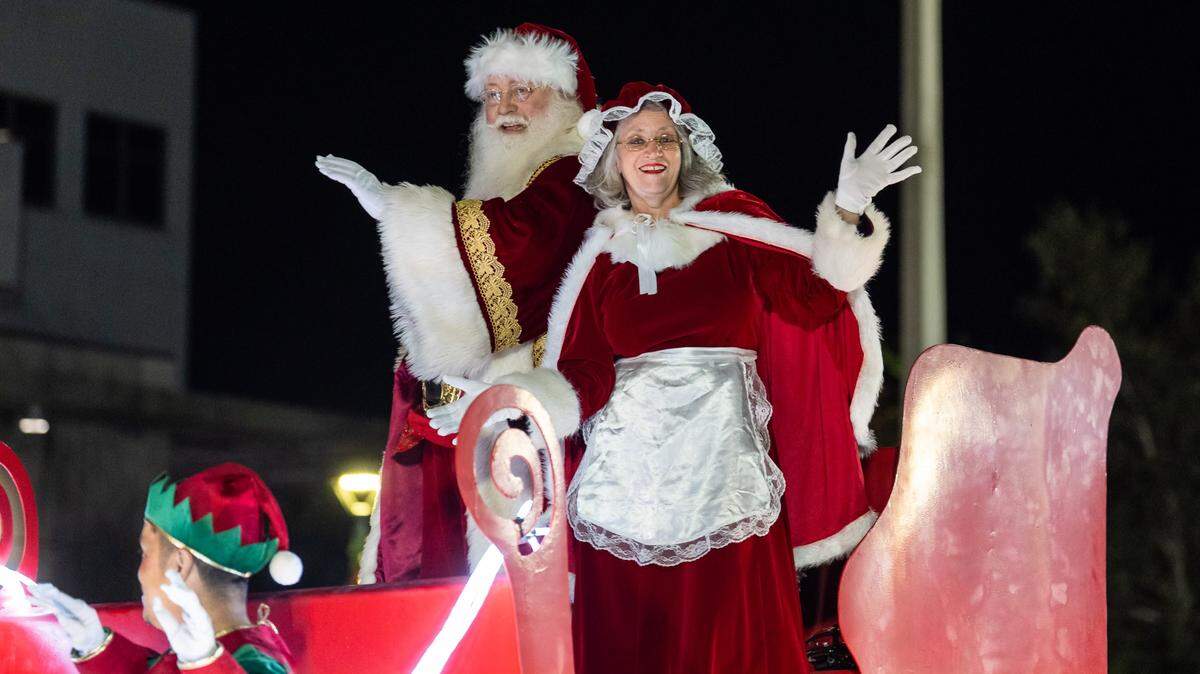 Santa and Mrs. Claus wave from their parade float during the annual holiday parade in Coral Springs.