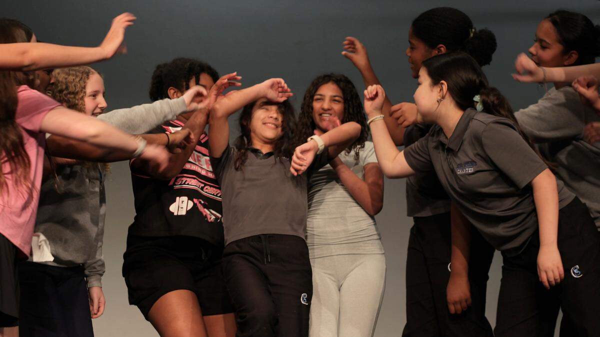 During a recent rehearsal, students pretend to beat up Molly, the smallest orphan at the group home, played by Melanie Villarroel (center).